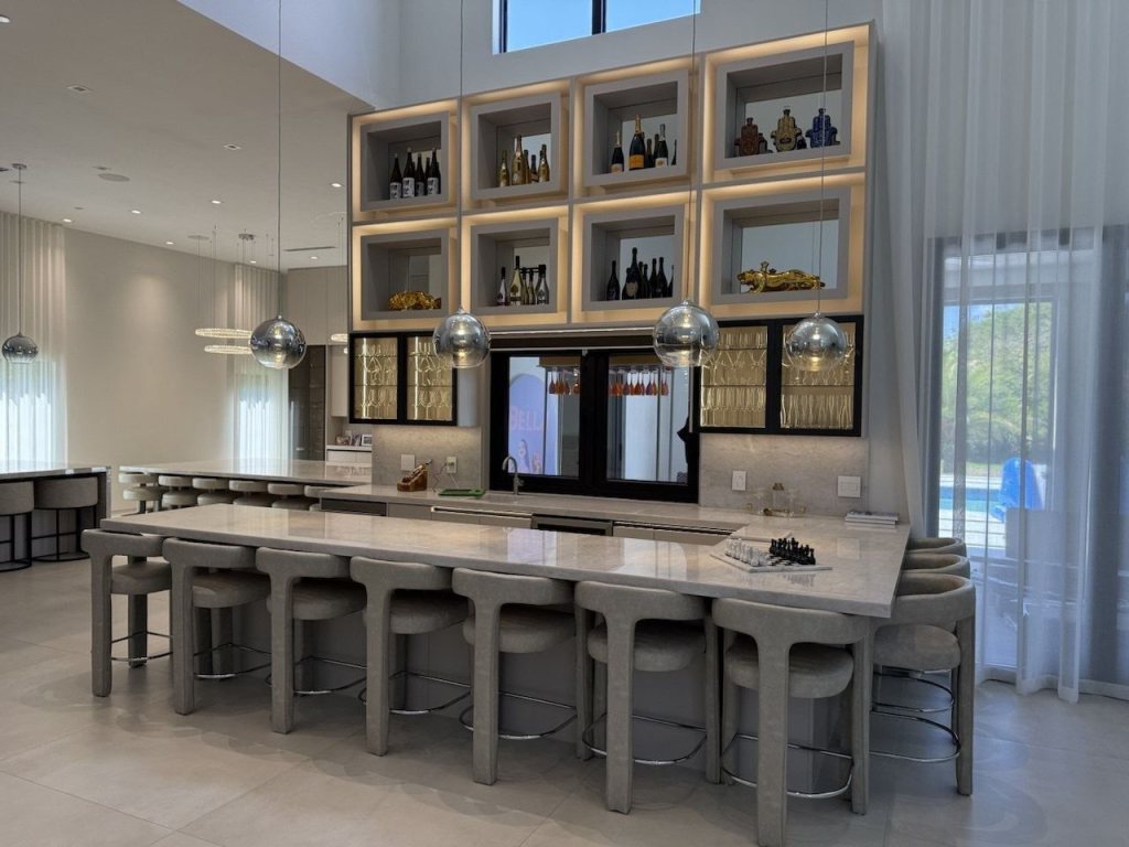 Kitchen with a lit display wall above the island