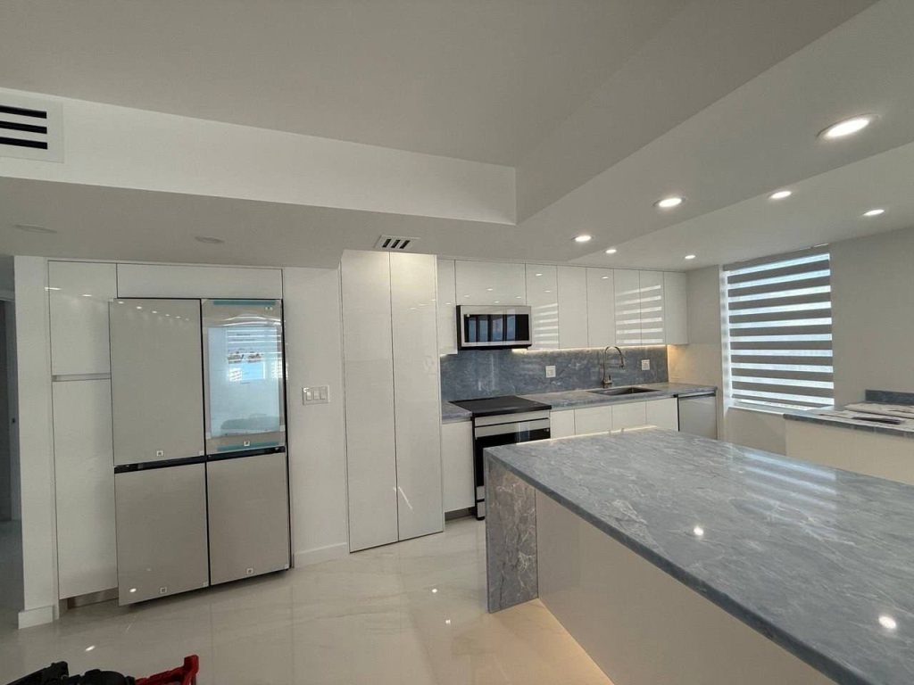 White kitchen with a gray stone island