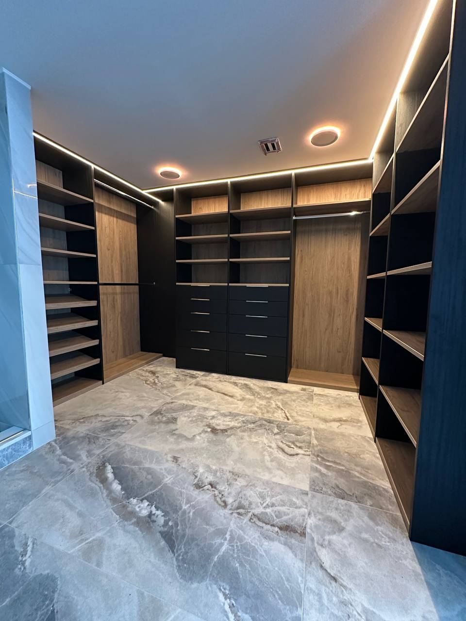Dark walk-in closet with LED lighting