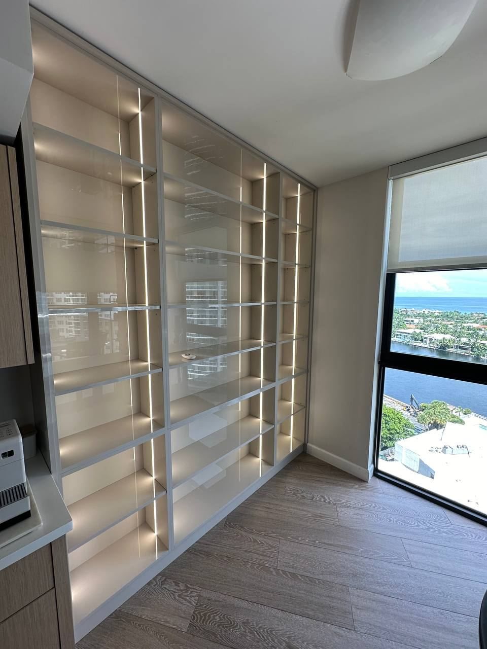 Closet with glass shelves and LED lighting